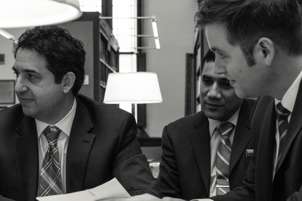 Photo of three men in suits in black and white